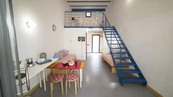 Family Quadruple Room | Living area | Flat-screen TV