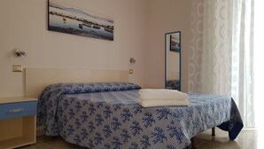 A bedroom with a bed, a nightstand, a mirror, and a painting on the wall. - B&B Napul'è (Naples)