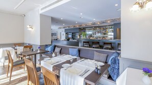 A restaurant with a bar area, wooden furniture, and a modern interior design. - Hotel Blausee (Kandergrund)