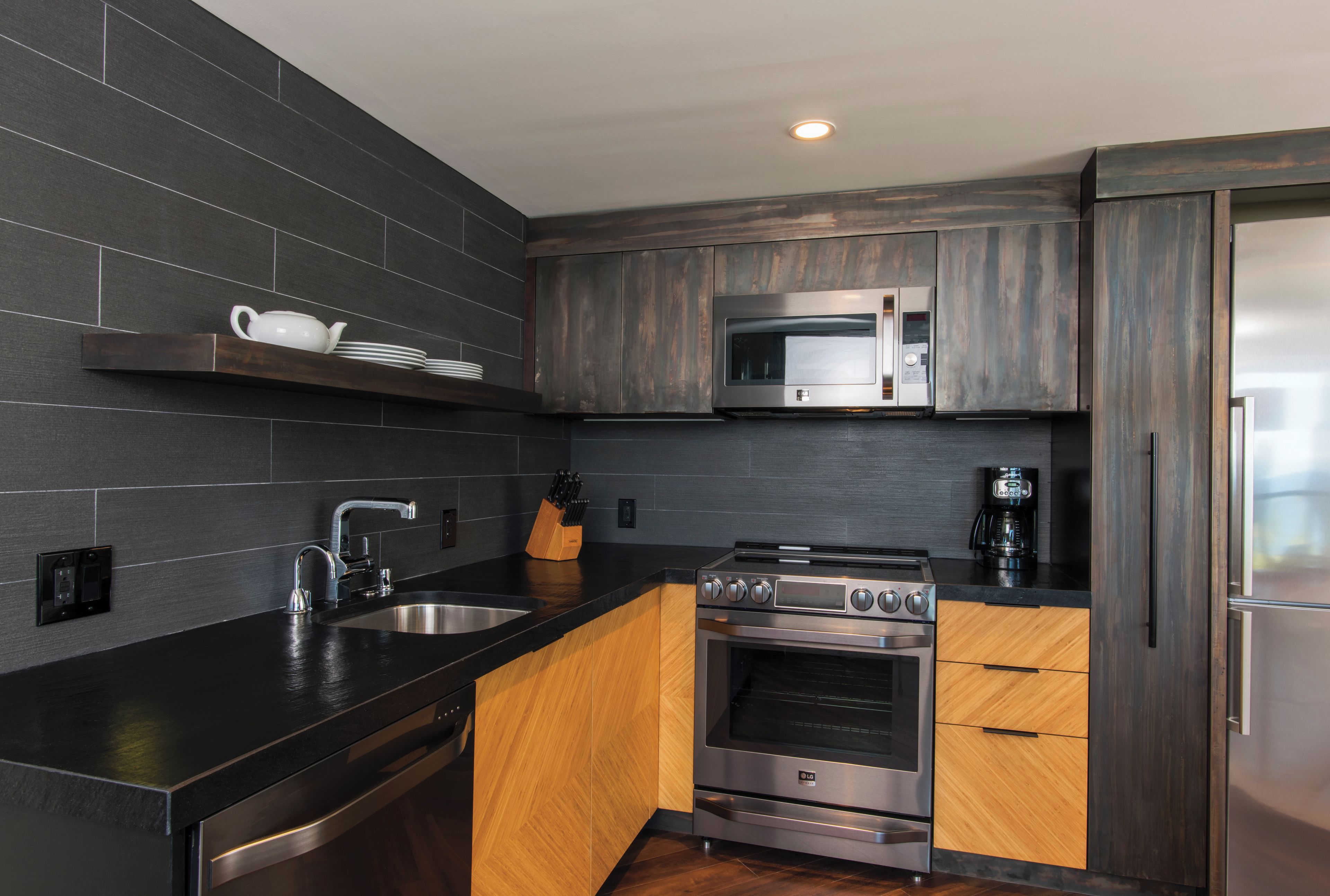 A modern kitchen with a built-in microwave, stove, and refrigerator.