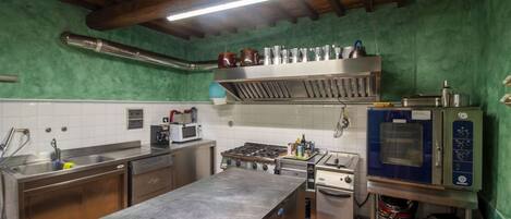 A kitchen with stainless steel appliances, a sink, and a tiled backsplash.