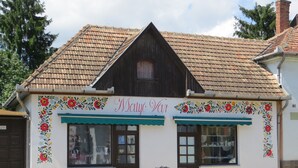 A traditional building with a sloped roof and floral decorations.