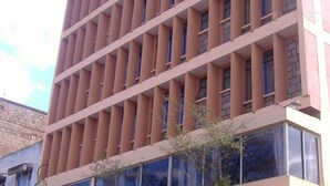 A multi-story building with a grid-like facade and large windows. - Batian Grand Hotel (Nyeri)