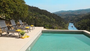 A swimming pool with lounge chairs and a view of a river and hills. - Private Pool with fantastic views over Douro River - Porto & Airport 1H (Marco De Canaveses)