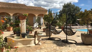 A courtyard with a pool, outdoor seating, and potted plants. - L'Oasis - a little paradise in Provence, big terrace and pool (Arles)