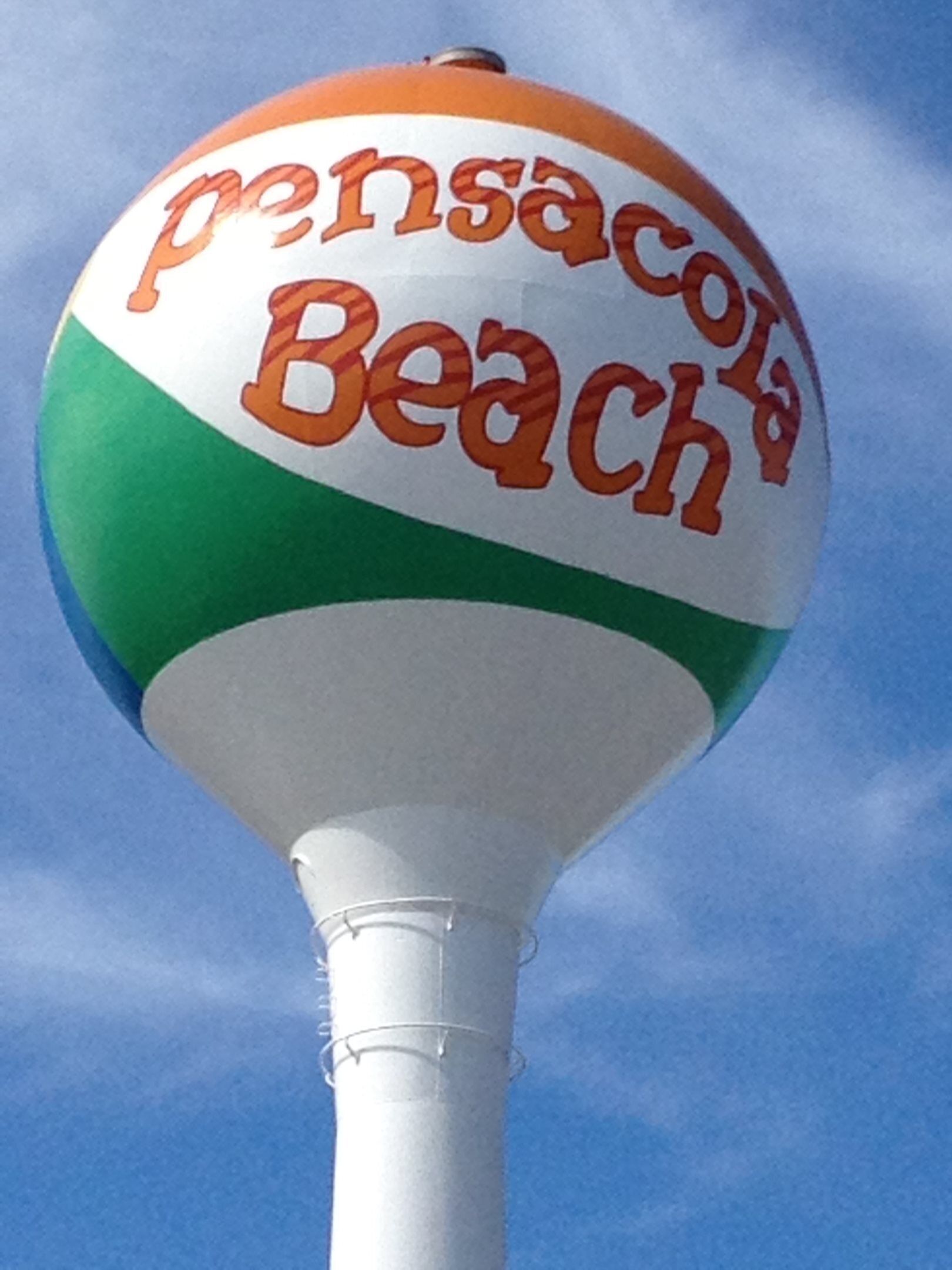 A beach ball with "Pensacola Beach" written on it.