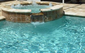 A swimming pool with a hot tub area featuring a tiled design and a water fountain. - Sun, beach, and great savings –discover amazing discounts on dream destinations! (Cape Coral)