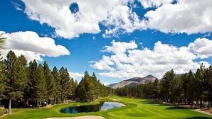 A golf course with a pond, trees, and mountains in the background. - Year round fun luxury location steps to Village, close to all outdoor activities (Mammoth Lakes)