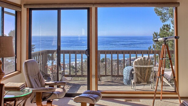 A room with large sliding glass doors leading to a balcony with a view of the ocean. - Panoramic Views From This Monthly Rental in Cambria! Stunning! (Cambria)