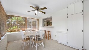 A room with a dining table, chairs, a ceiling fan, a window with blinds, and a white wardrobe. - Spacious 3 Bedroom 2 Bath Walk to Eagle Lake Park Fenced Yard (Clearwater)