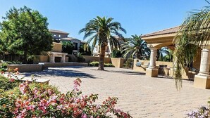 A courtyard with palm trees, a pergola, and a paved walkway. - Country Club 1092 heated pool, 1000 feet from Golfland Sunsplash Amusement Park (Mesa)
