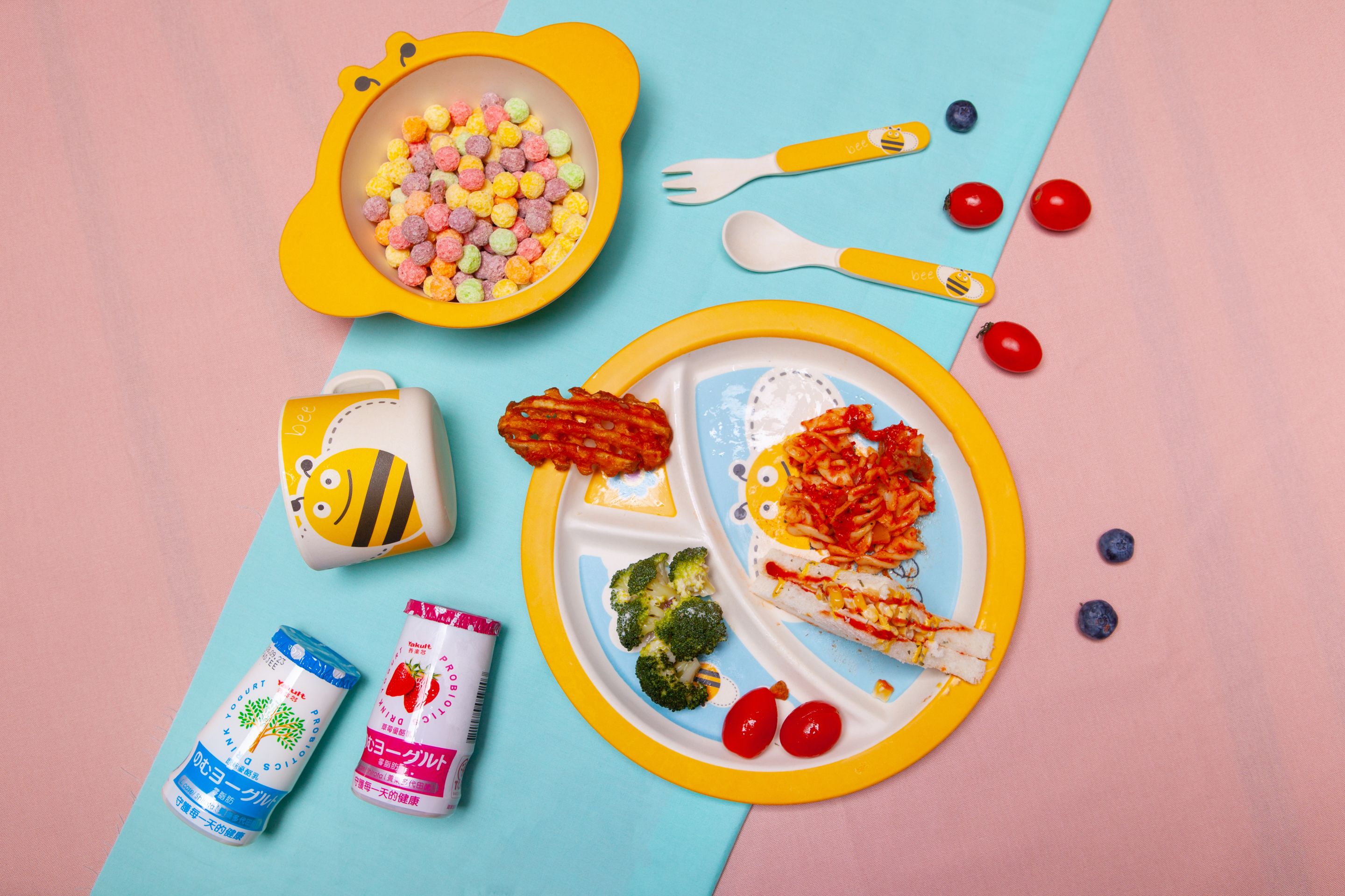 A meal with a plate, utensils, and two drinks on a table.