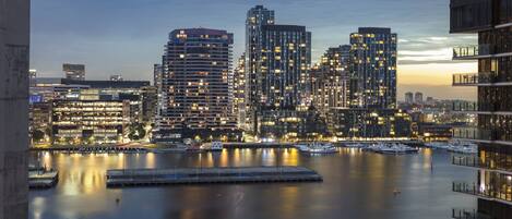 A waterfront cityscape with high-rise buildings and a marina.