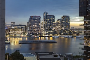 A waterfront cityscape with high-rise buildings and a marina.