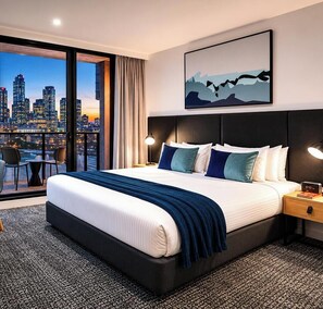 A modern hotel room with a large bed, a city view, a desk, and a chair. - Quest NewQuay (Docklands)