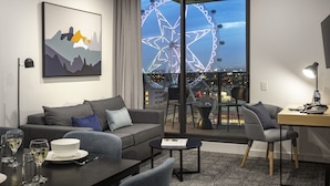 A modern hotel room with a large window, a sofa, a dining table, and a desk. - Quest NewQuay (Docklands)