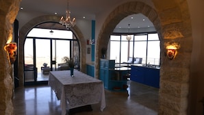 A spacious interior with a dining area, kitchen, and large windows. - Villa Herodion (Tekoa)