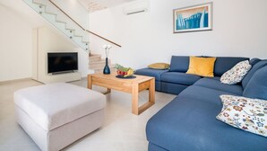 A modern living room with a staircase, a flat-screen TV, a sofa, and a coffee table. - Stunning private villa for 8 people with WIFI, A/C, private pool, TV and terrace (Pazin)