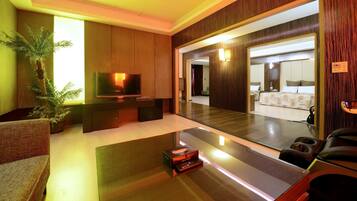 Deluxe Quadruple Room, 2 Queen Beds, Non Smoking | Living room | 42-inch LED TV with cable channels, TV, DVD player