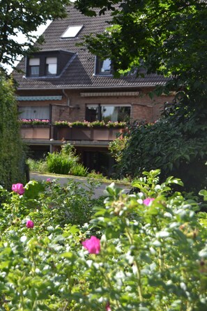 A two-story house with a sloped roof, a visible attic window, and a brick facade. - Ferienwohnung Schelsen (Moenchengladbach)