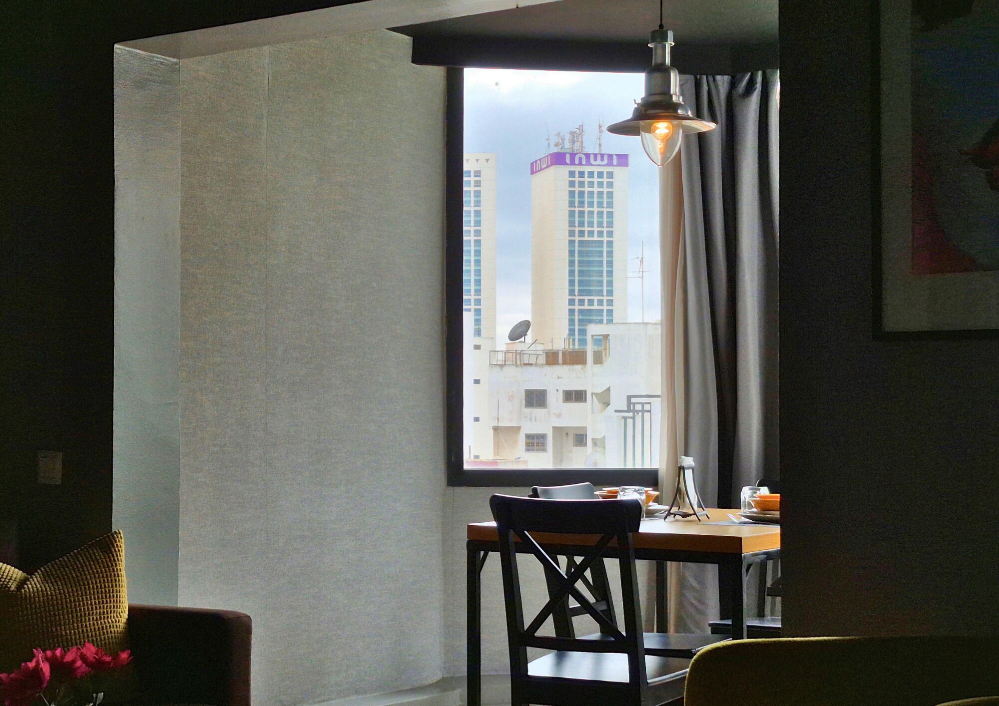 A room with a window, a table, and a chair.