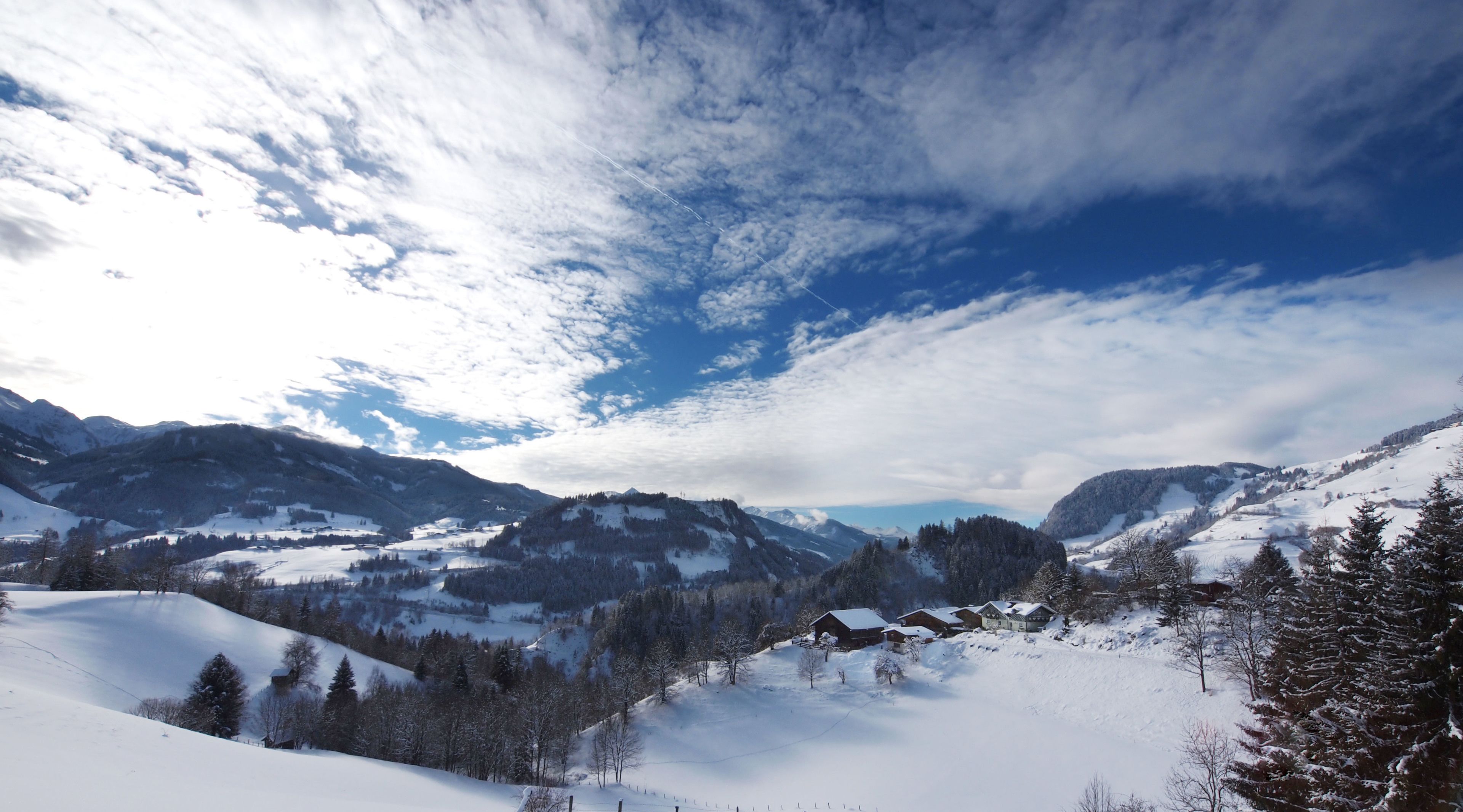 Eine verschneite Berglandschaft mit blauem Himmel.