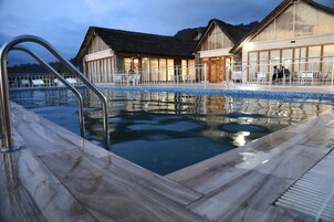 Una piscina al aire libre, camas de piscina gratis, sombrillas