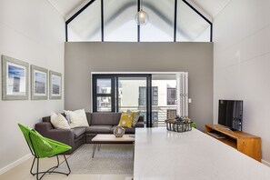 Family Apartment, 2 Bedrooms, Partial Ocean View | Living area | 42-inch flat-screen TV with satellite channels, TV - Azure 213 On Big Bay (Cape Town)