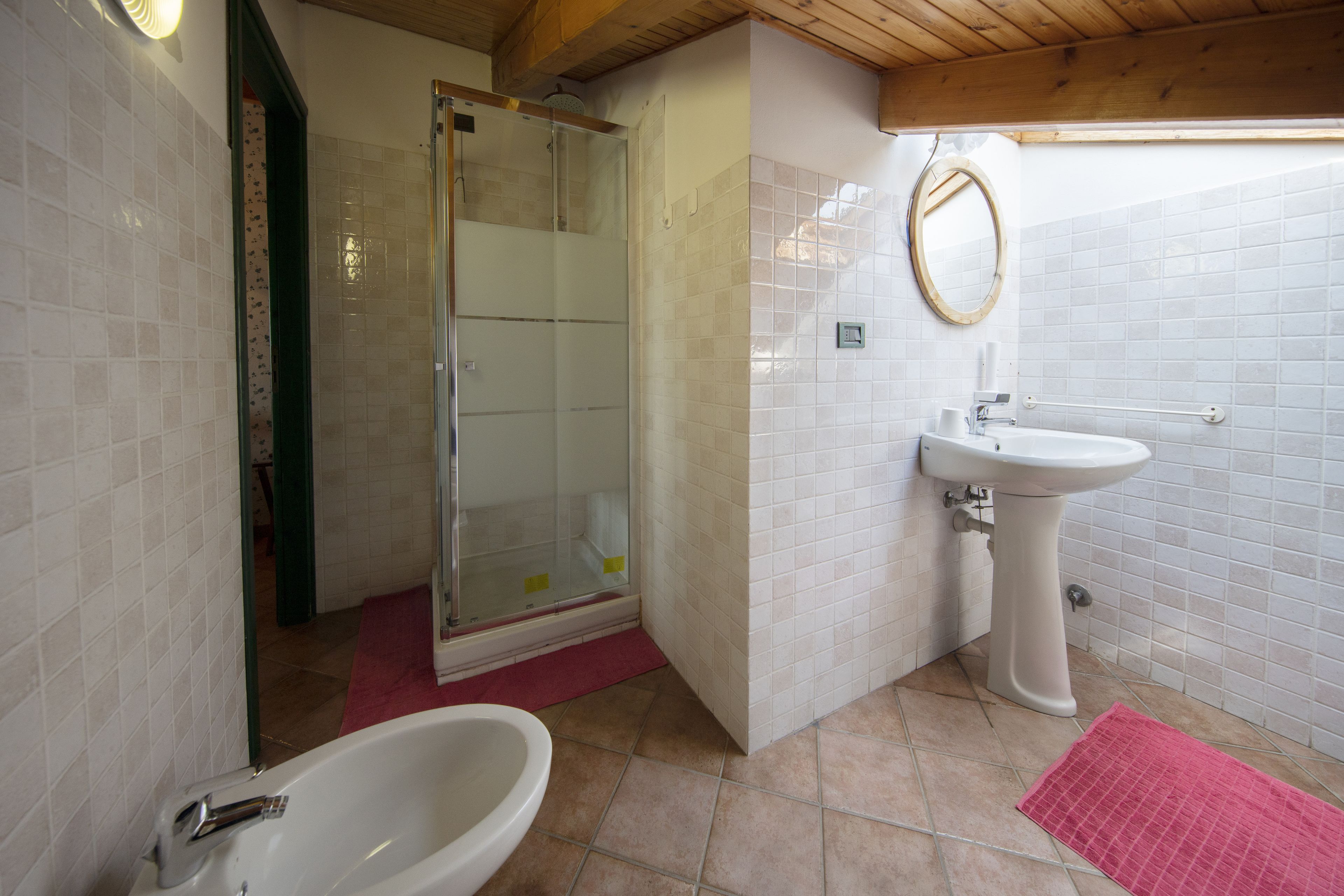 A bathroom with a shower, sink, and bathtub.