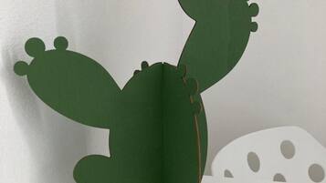 A cactus-shaped paper decoration with a pair of keys and a blue-handled knife beside it.