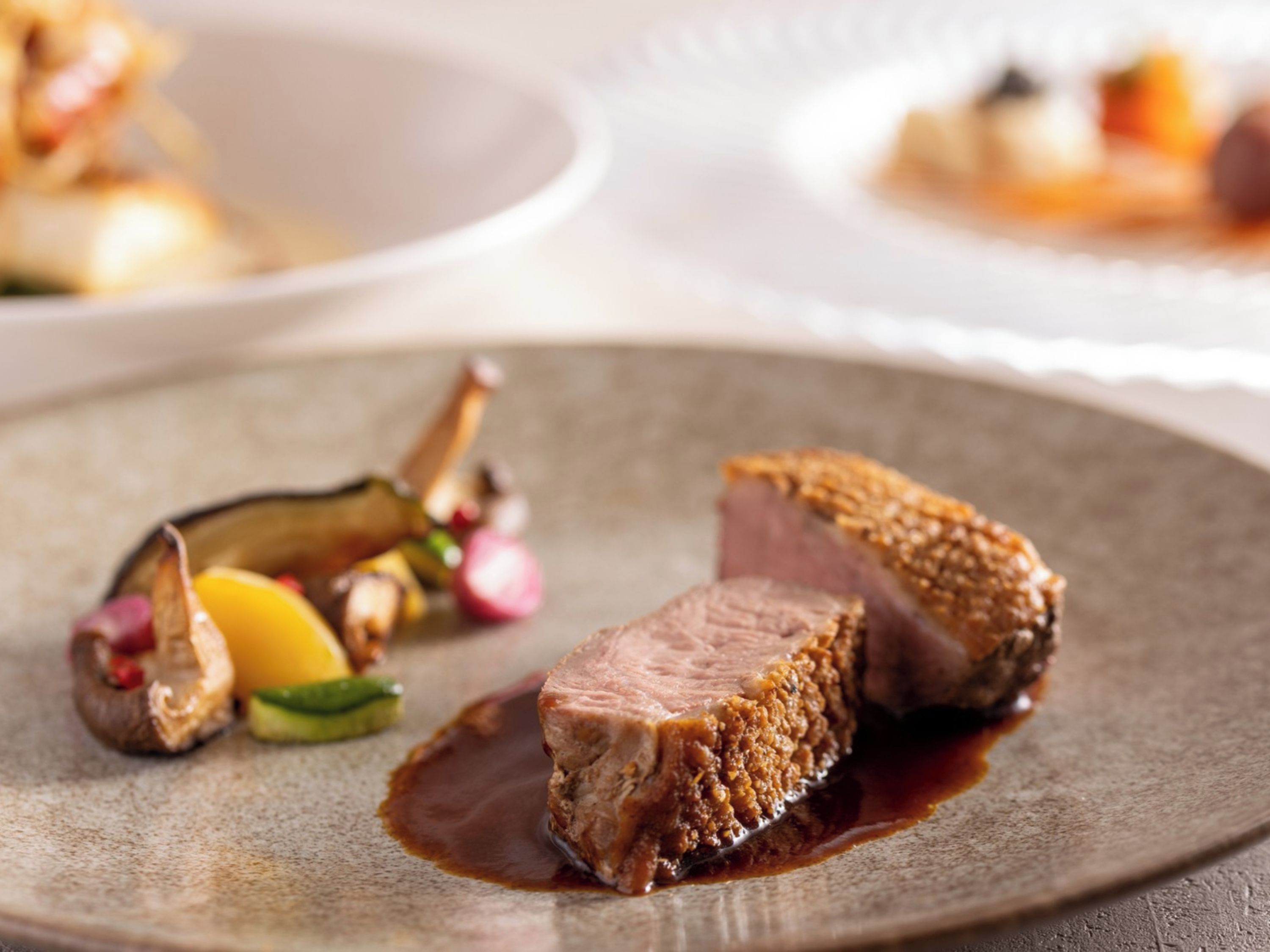 A plate with a piece of meat and vegetables.