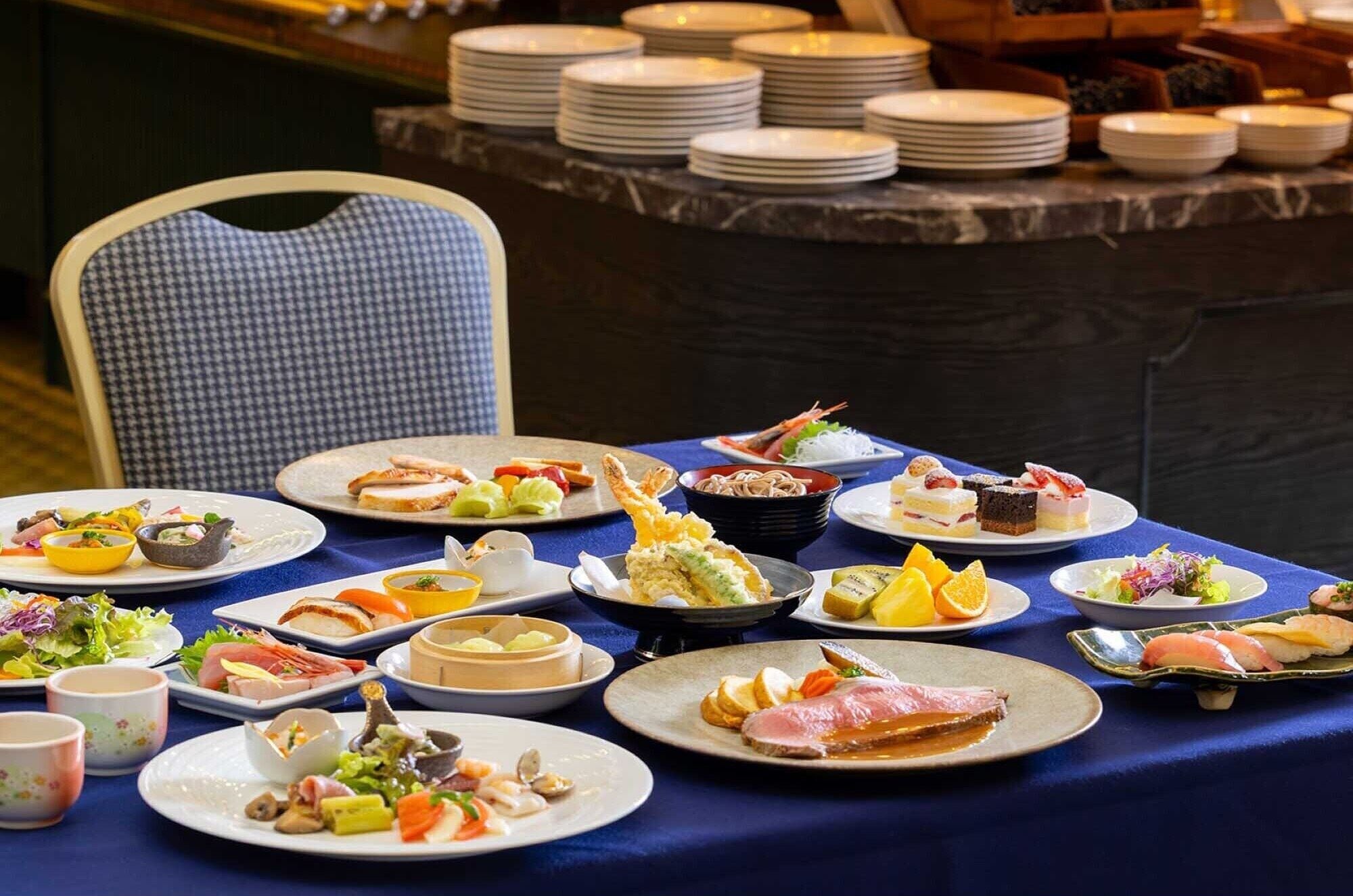 A buffet table with various dishes and plates.