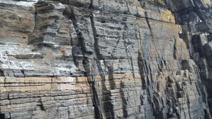 A rock formation with layered strata. - The Antlers (Lybster)