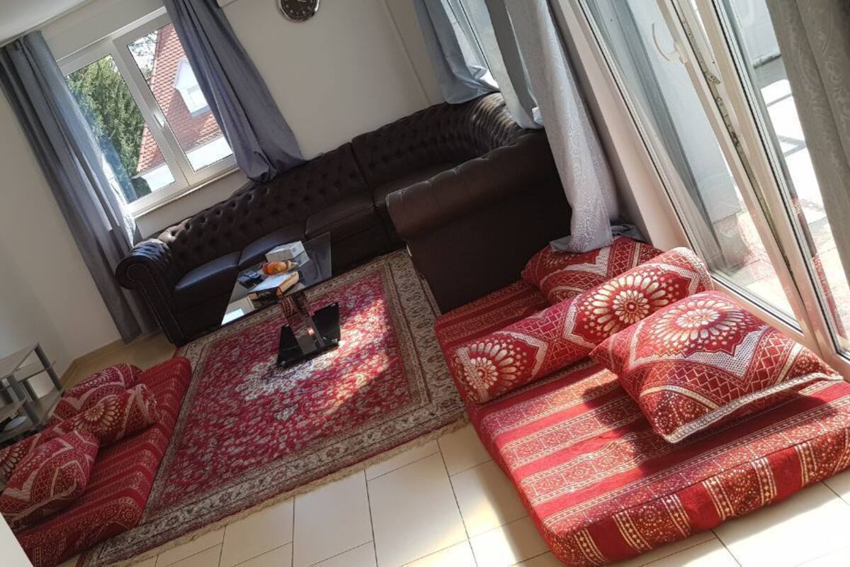 Un salon comprenant un canapé, une table basse et un téléviseur fixé au mur.