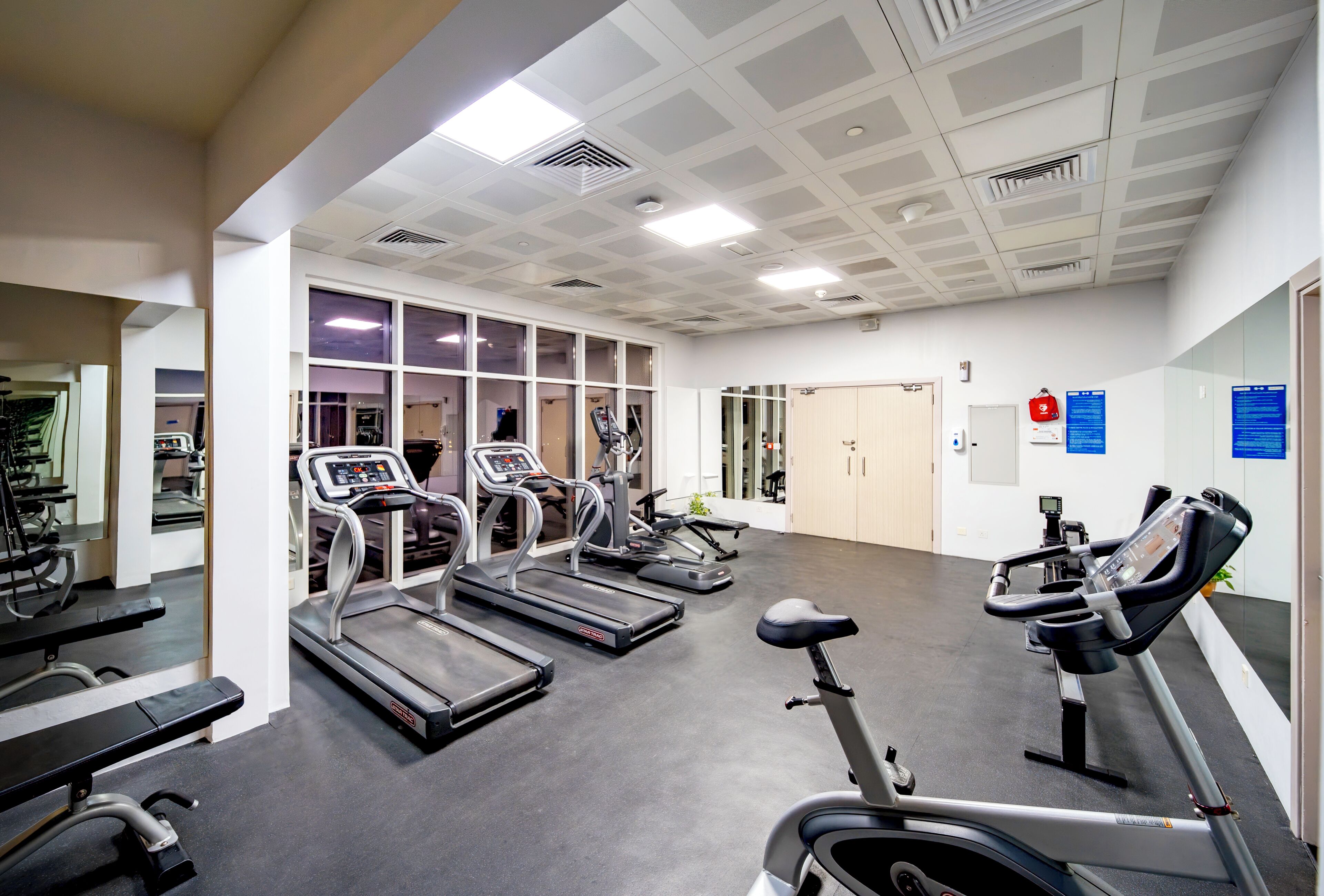 A gym with treadmills, stationary bikes, and weight machines.