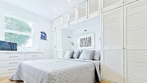 A bedroom with a bed, a TV, a window, and a wardrobe. - Luxury Designer Apartments Hammersmith 1 (London)