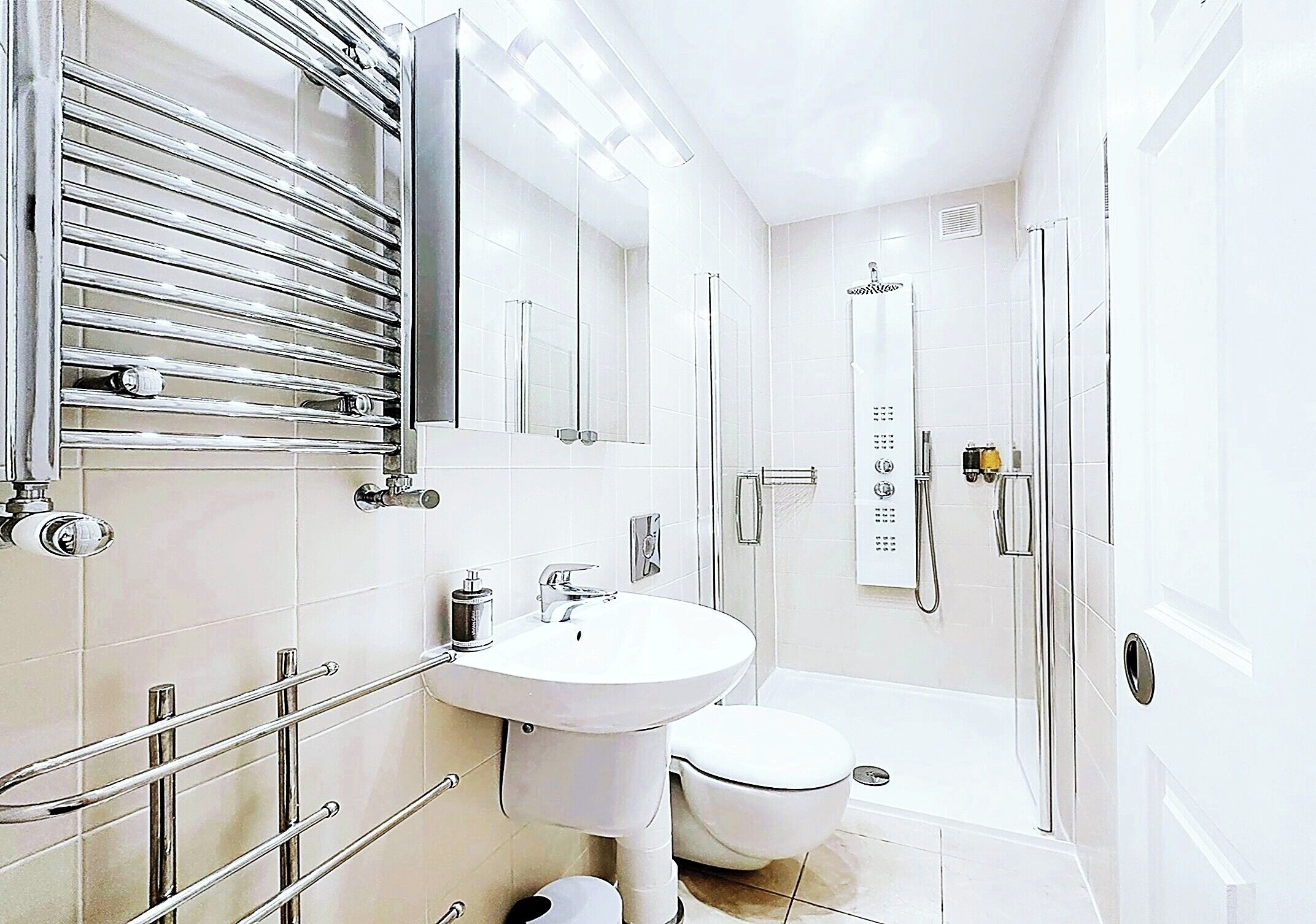 A modern bathroom with a toilet, sink, and shower.
