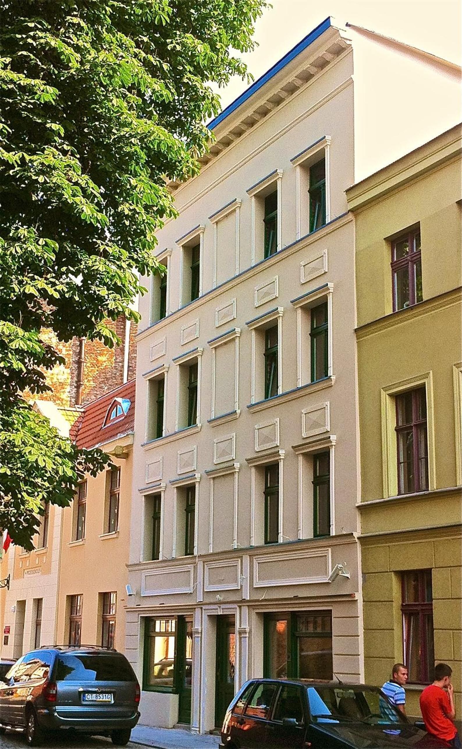 A multi-story building with a classical architectural style, featuring a symmetrical facade with evenly spaced windows and a central entrance.