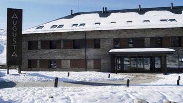 A building with a sign reading 'AUGUSTA' and a snow-covered roof.