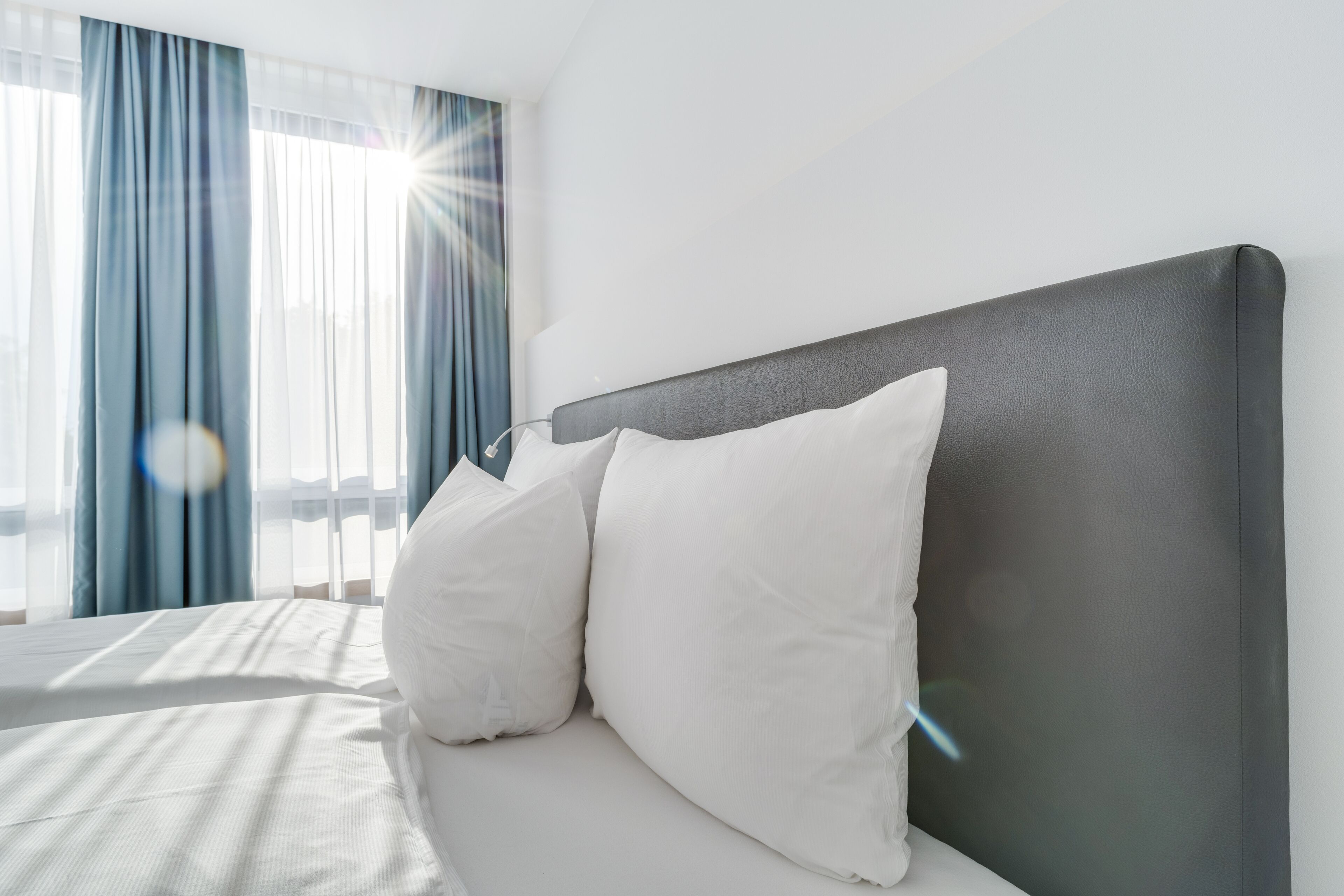 hypo-allergenic bedding, desk, laptop workspace, blackout curtains