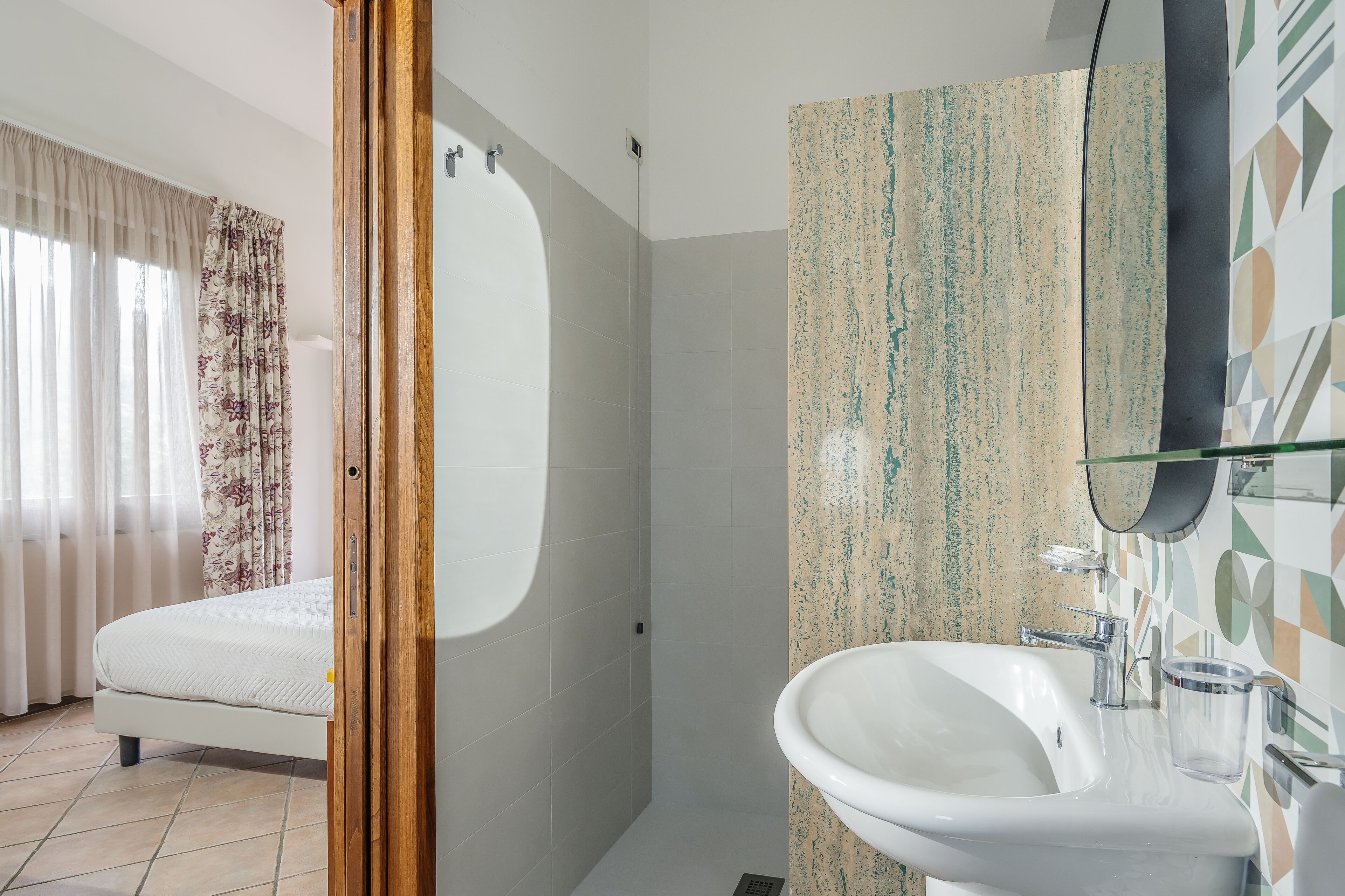 A modern bathroom with a bathtub, a sink, and a shower.