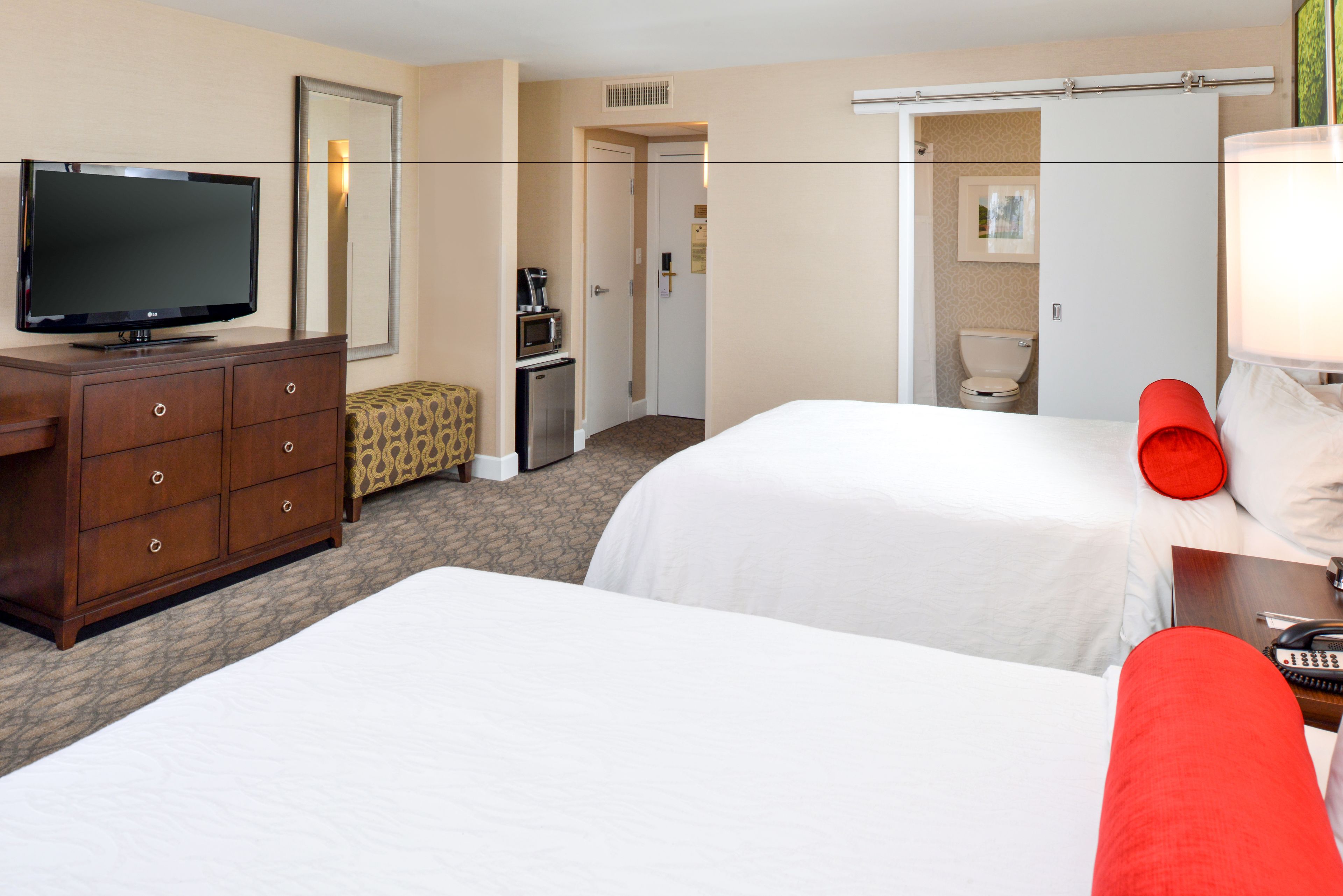 standard room, 2 queen beds, refrigerator & microwave | in-room safe, desk, iron/ironing board, rollaway beds