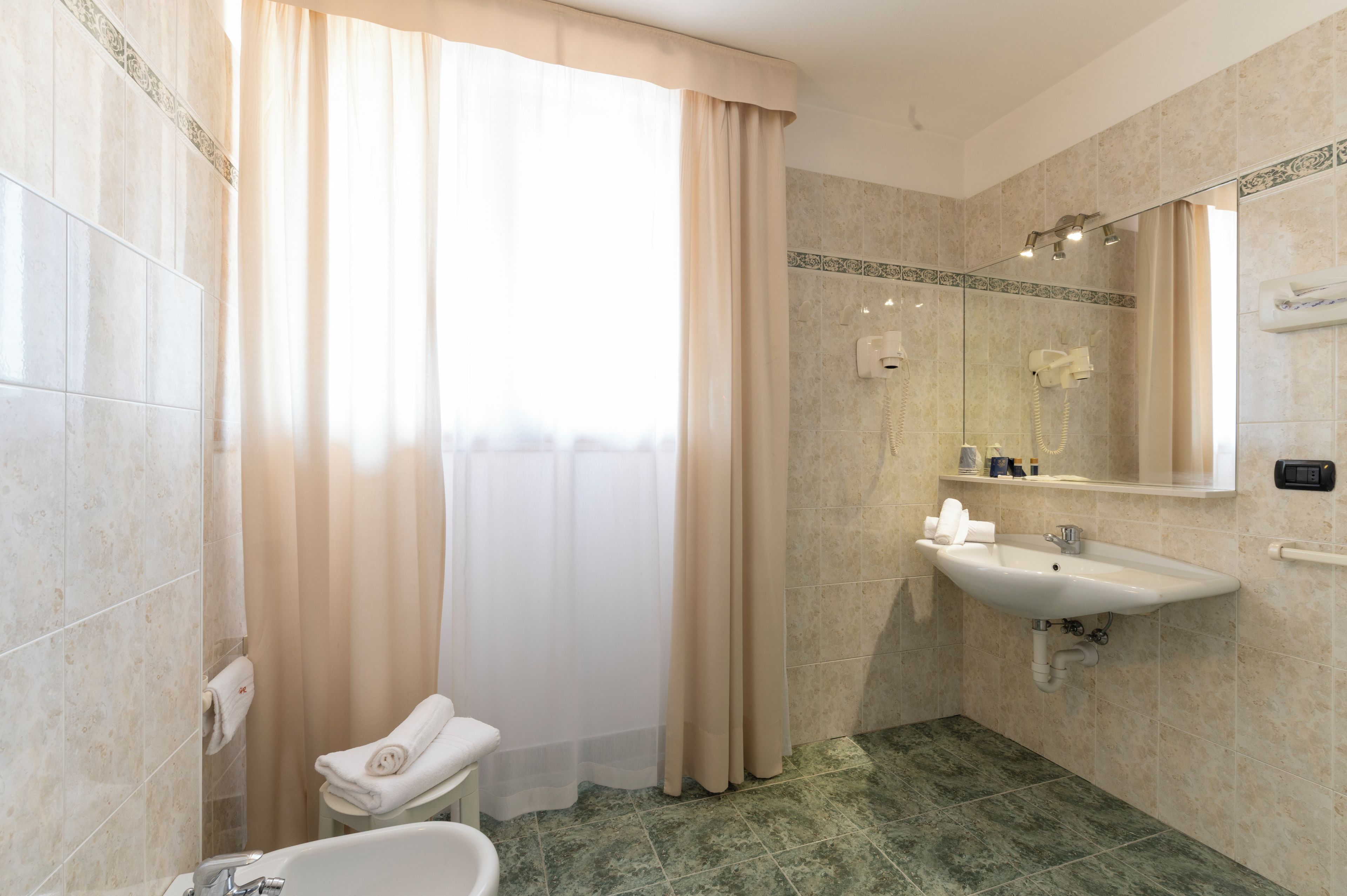A bathroom with a bathtub, a sink, and a toilet.