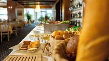 Una mesa de buffet con diferentes alimentos y una botella de jugo.