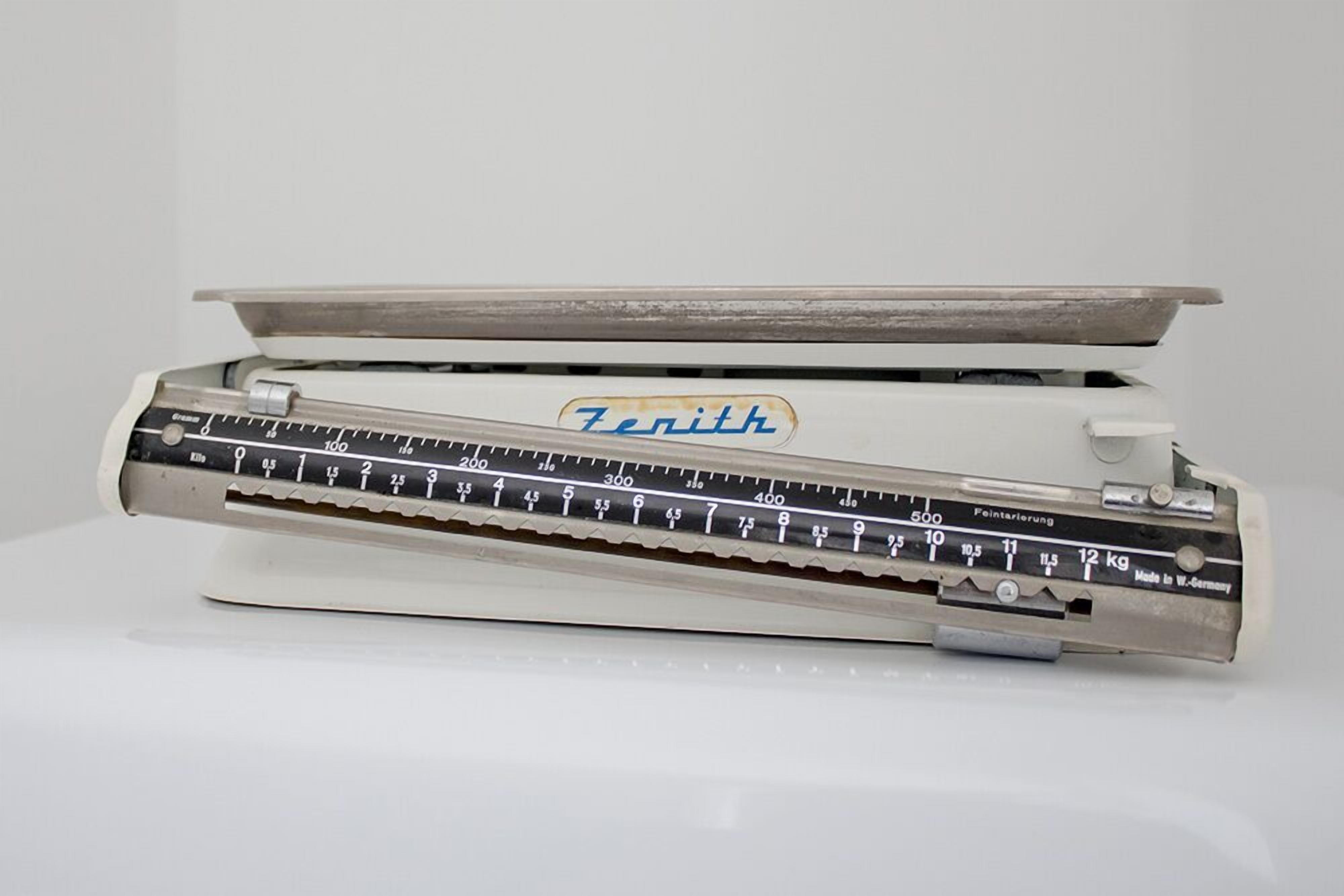 A vintage Zenith typewriter with a ruler and weight scale.