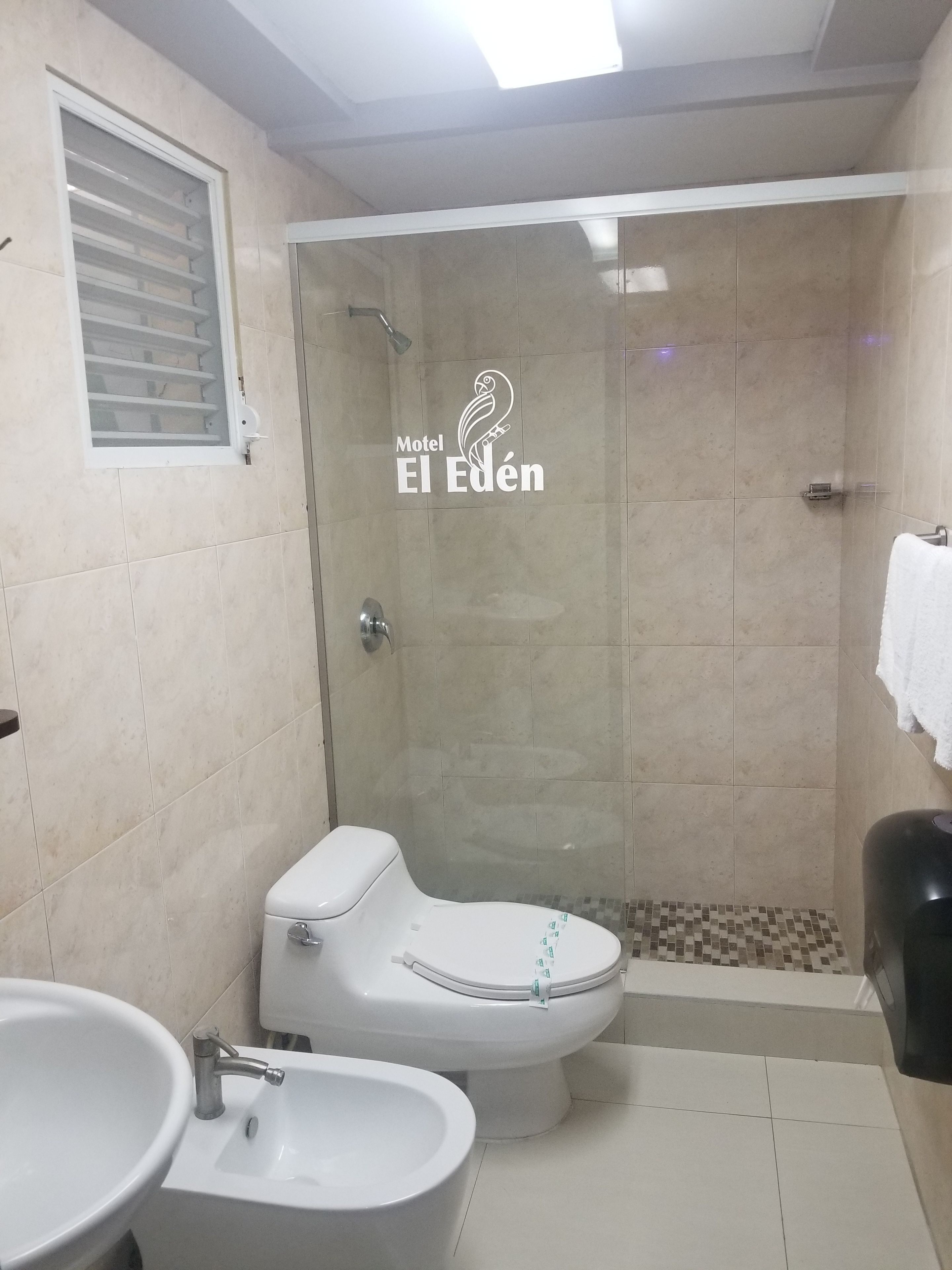 A bathroom with a toilet, bidet, and sink.