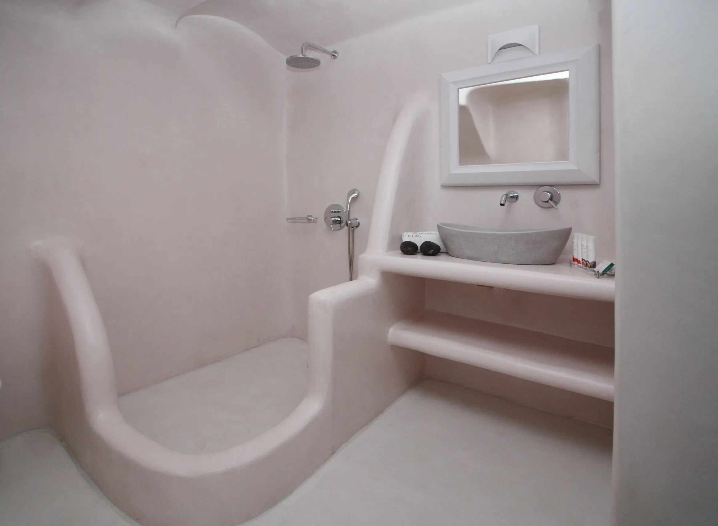 A bathroom with a bathtub, a sink, and a mirror.