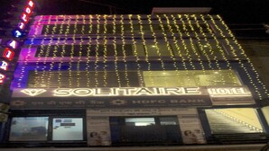 A hotel with a prominent sign for Solitaire Hotel and HDFC Bank. - Solitaire Hotel (New Delhi)