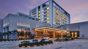 A modern hotel with a prominent entrance, multiple floors, and a well-lit facade. - Courtyard by Marriott Madurai (Madurai)