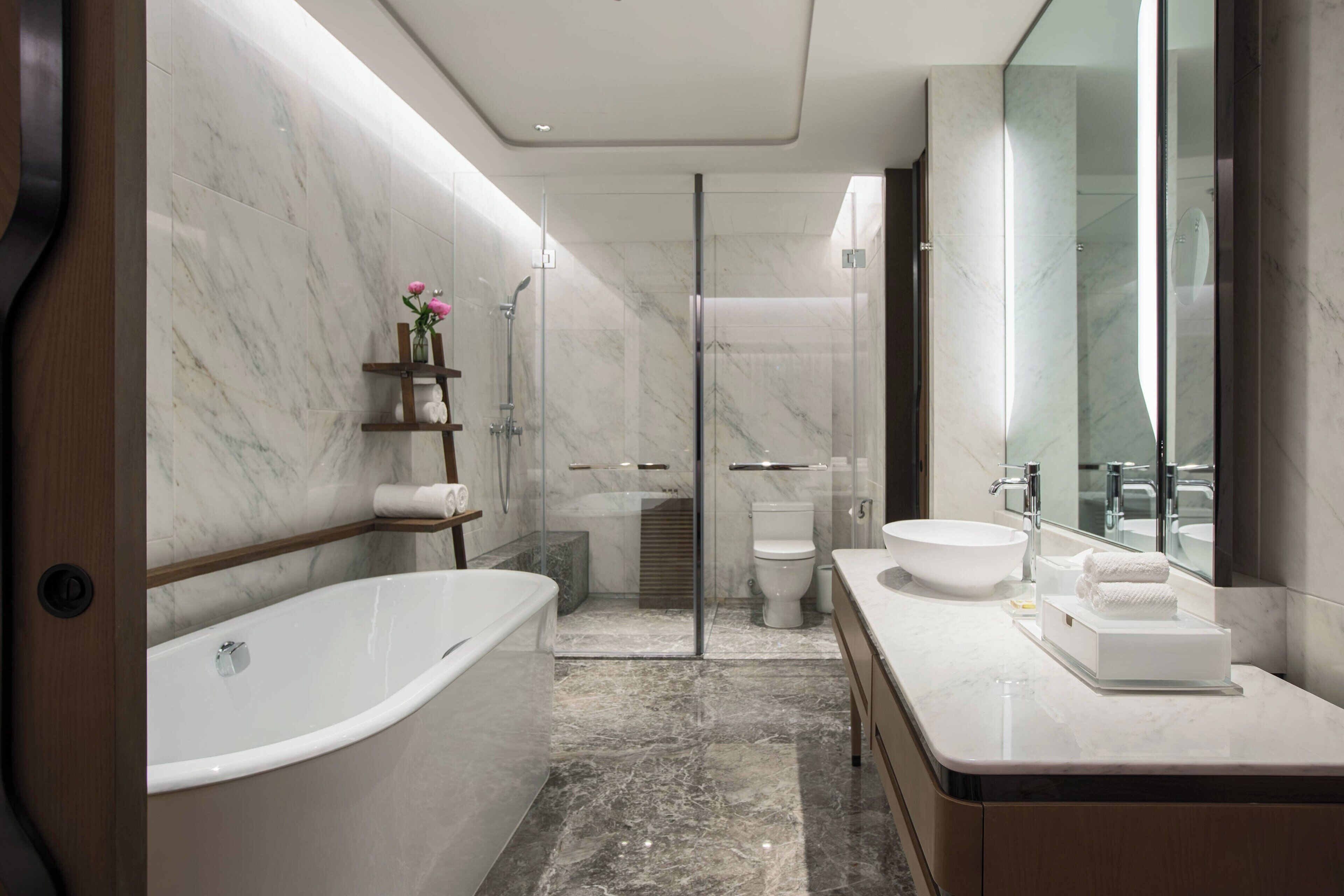 deep-soaking bathtub, hair dryer, slippers, towels